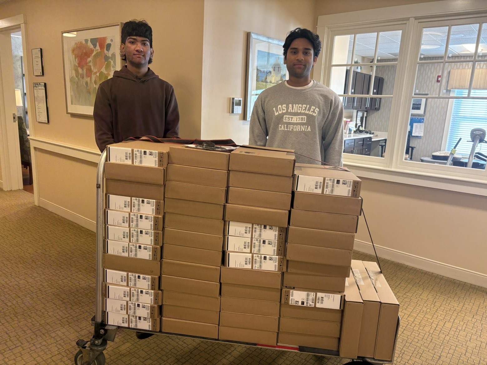 NASTP volunteers with a cart of donated laptops from the MBI grant