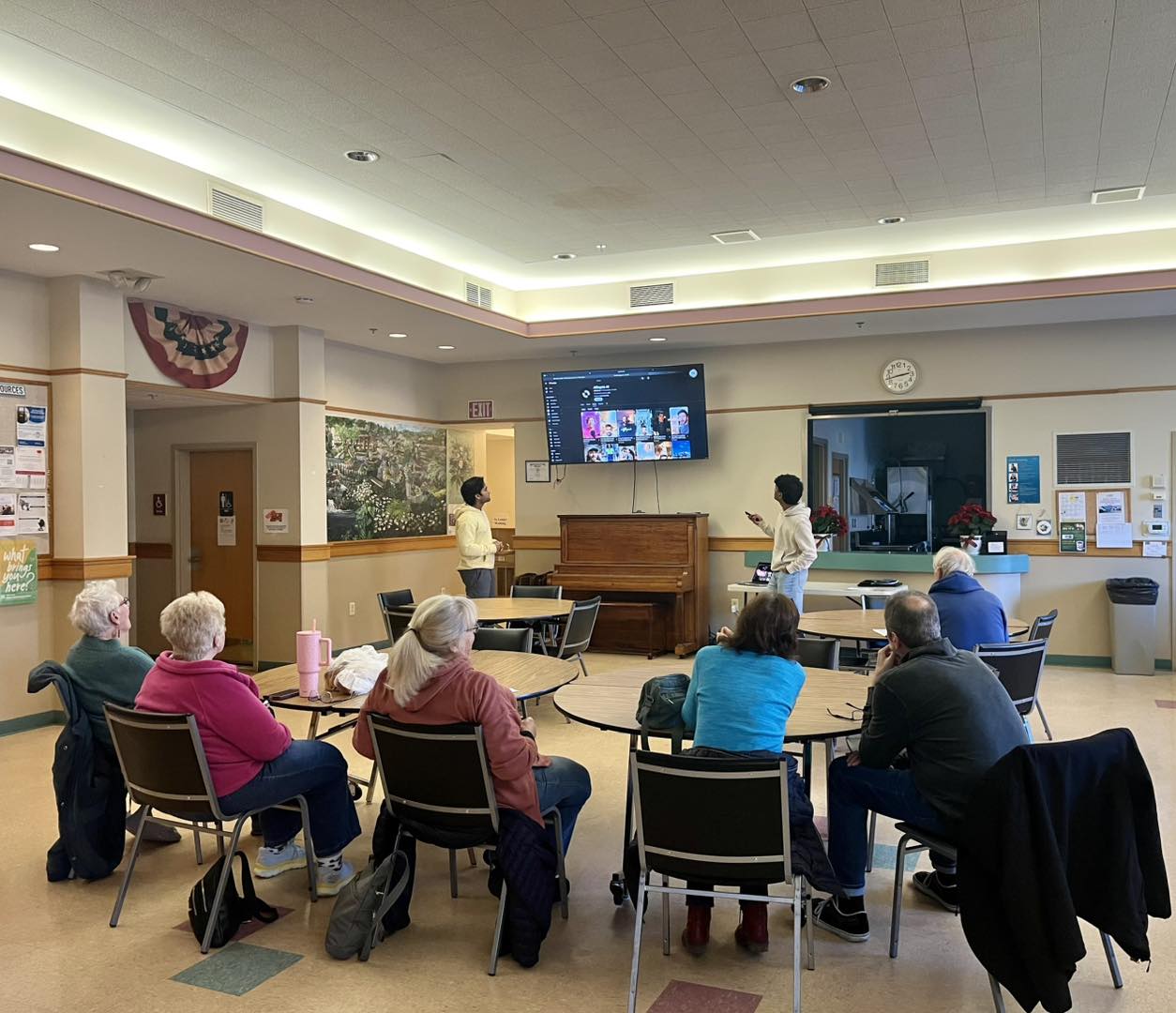 A NASTP volunteer presenting a workshop to a room of seniors